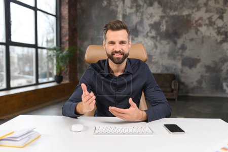 Photo for Businessman talking with colleagues or clients during video call, looking into the camera and gesturing, communicating on the distance, use modern videoconference - Royalty Free Image