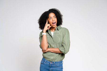 In a moment of sudden realization, an African-American woman gestures towards her head, her expression one of surprised insight, on a simple background