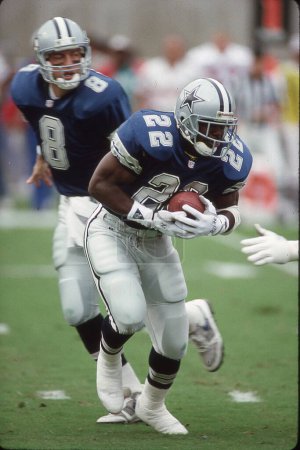 Photo for Dallas Cowboys RB Emmitt Smith receives the handoff from QB Troy Aikman during NFL action during the 1990s. - Royalty Free Image