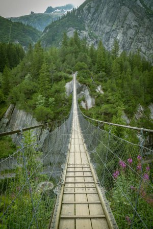 Suspension bridge close to Grimselpass in Swiss Alps in Switzerland
