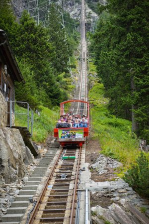 Photo for Guttannen, Switzerland - August 11, 2019: Tourists in open funicular riding from Gelmersee approaching valley station in Switzerland, during summer 2019 - Royalty Free Image