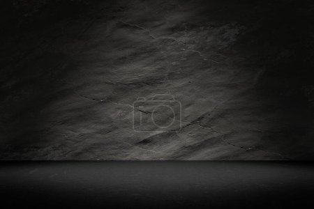 Empty space of dark studio room with concrete wall and spot light beam.
