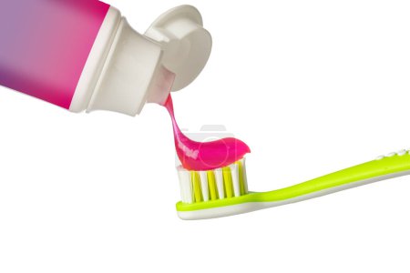 Foto de Aplicar pasta rosa sobre el cepillo de dientes sobre fondo blanco - Imagen libre de derechos