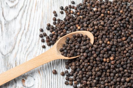 Photo for Black pepper on wooden spoon - Royalty Free Image