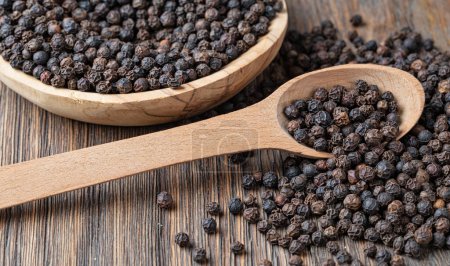 Photo for Black pepper on wooden spoon - Royalty Free Image