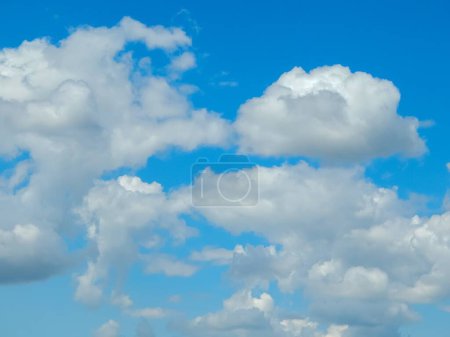 A stunning blue sky filled with soft, fluffy clouds, creating a peaceful and serene atmosphere. Ideal for various design projects that require a touch of nature and beauty.