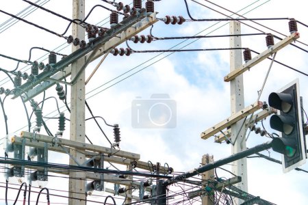 Photo for Three-phase electric power for transfer power by electrical grids. Electric power for support manufacturing industry. High voltage electric poles and wire lines against blue sky and white clouds. - Royalty Free Image