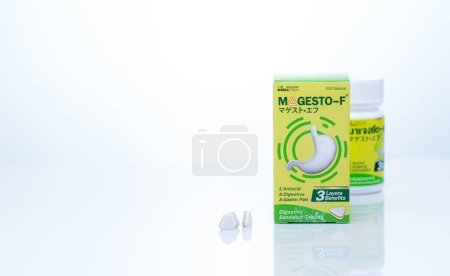Photo for CHONBURI, THAILAND-SEPTEMBER 23, 2022: Magesto-F tablets pill with drug bottle and paper box packaging. Licensed by Takeda Pharmaceutical company. Digestive sandwich tablets. Healthcare product. - Royalty Free Image