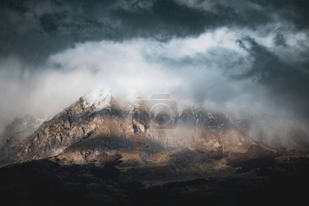 clouds over the mountains covered in snow
