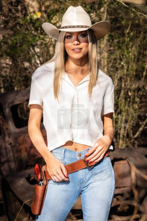 Photo for A gorgeous blonde cowgirl model poses outdoors while enjoying the spring weather - Royalty Free Image