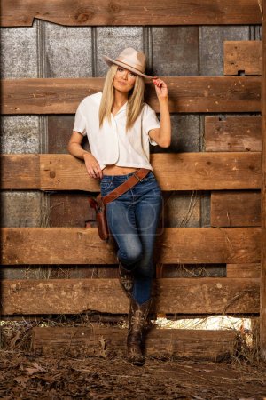 Photo for A gorgeous blonde cowgirl model poses outdoors while enjoying the spring weather - Royalty Free Image