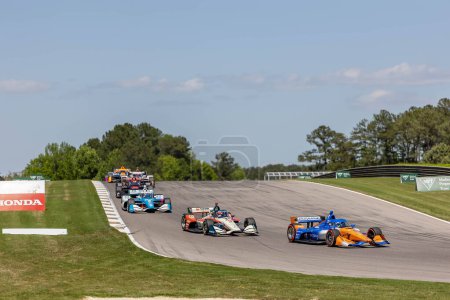Photo for SCOTT DIXON (9) of Auckland, New Zealand races through the turns during the Childrens of Alabama Indy Grand Prix at the Barber Motorsports Park in Birmingham AL. - Royalty Free Image