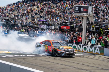 Photo for NASCAR Driver, Martin Truex, Jr, celebrates his win for the Toyota SaveMart 350 at the Sonoma Raceway in Sonoma CA. - Royalty Free Image