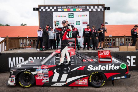 Photo for Corey Heim celebrates in victory lane after winning the O'Reilly Auto Parts 150 at Mid-Ohio at the Mid-Ohio Sports Car Course in Lexington OH. - Royalty Free Image