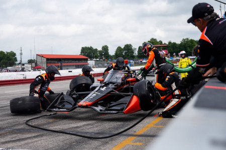 Photo for The crew of AJ Foyt Racing  preforms a pit stop during the Honda Indy 200 at Mid-Ohio at Mid-Ohio Sports Car Course in Lexington OH. - Royalty Free Image