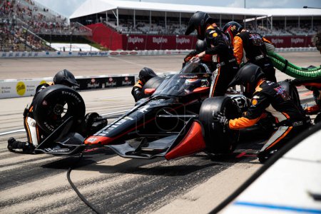 Photo for The crew of AJ Foyt Racing  performs a pit stop during the HyVee Indycar Weekend  at Iowa Speedway in Newtown IA. - Royalty Free Image