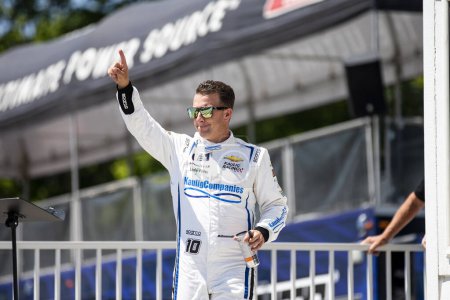 Photo for AJ Allmedinger walks across the stage during driver intros prior to the Road America 180 at Road America in Elkhart Lake WI. - Royalty Free Image