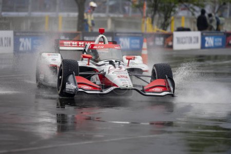 Photo for INDYCAR Series driver, STING RAY ROBB (R) (51) of Payette, Idaho, travels through the turns during a wet and dangerous practice session for the Big Machine Music City Grand Prix at Streets of Nashville in Nashville TN. - Royalty Free Image