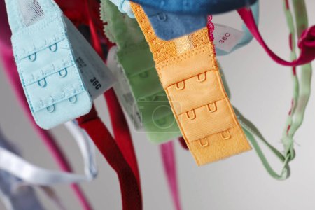 Photo for A group of colorful bras hang on a clothes line in a studio environment - Royalty Free Image