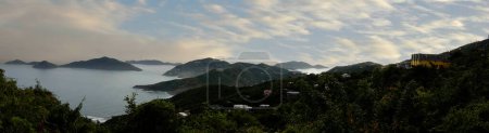 Photo for Tortola, in the British Virgin Islands, captivates with lush hills, white sand beaches, and vibrant homes, showcasing Caribbean charm amid stunning seascapes - Royalty Free Image