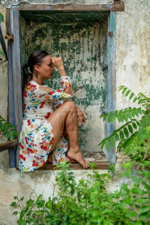 A gorgeous latin model poses in a abandoned pueblo in the Mexican province of Yucatan