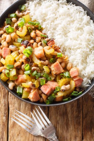 Photo for Homemade Southern Hoppin John with Rice and Pork closeup on the plate on the wooden table. Vertical top view from abov - Royalty Free Image