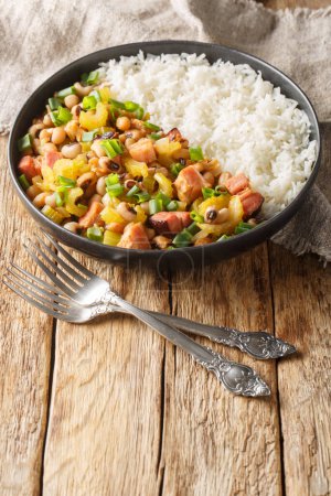 Photo for Homemade Southern Hoppin John with Rice and Pork closeup on the plate on the wooden table. Vertica - Royalty Free Image