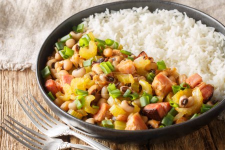 Photo for Hoppin John or Carolina peas and rice, is a black-eyed peas and rice with vegetables dish closeup on the plate on the wooden table. Horizonta - Royalty Free Image