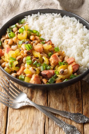 Photo for Hoppin John is one of those classic Southern dishes made of black-eyed peas and rice closeup on the plate on the wooden table. Vertica - Royalty Free Image