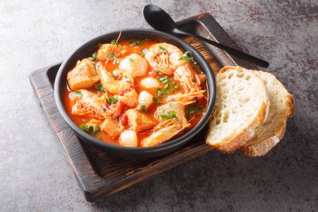 Photo for Brudet is a hearty fish stew from the Dalmatia region of Croatia, similar to Greek Bourdeto and Italian Brodetto close-up in a bowl on the table. Horizonta - Royalty Free Image