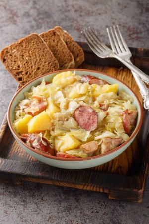 Photo for German Jager Kohl, hunter's cabbage with Sausage, Bacon and Potatoes close-up in a bowl on the table. Vertica - Royalty Free Image