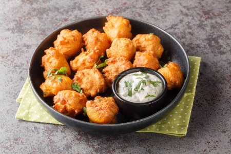 Photo for Hush puppies Deep fried cornmeal balls made with onions, garlic and butter closeup on the plate on the table. Horizonta - Royalty Free Image