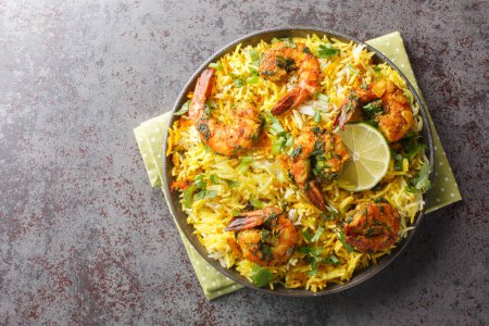 Photo for Popular Iranian seafood pilaf Meygoo Polo with herbs and prawns closeup on the plate on the table. Horizontal top view from abov - Royalty Free Image