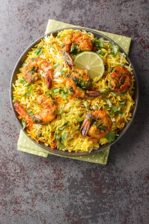 Photo for Meygoo Polo pilaf Rice with herbs and prawns closeup on the plate on the table. Vertical top view from abov - Royalty Free Image