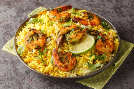 Photo for Popular Iranian seafood pilaf Meygoo Polo with herbs and prawns closeup on the plate on the table. Horizonta - Royalty Free Image