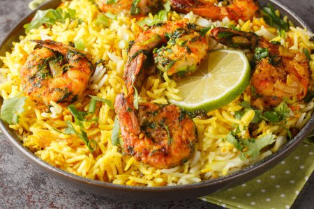 Photo for Asian saffron pilaf with shrimp and lots of herbs such as dill, green onions, cilantro close-up on a plate on the table. Horizonta - Royalty Free Image