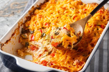 King Ranch Chicken Casserole is a Southern Texas staple dish close-up in a baking dish on a marble table. Horizonta