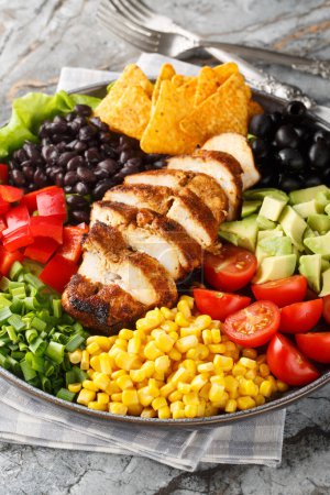 Photo for Southwest Salad or Santa Fe Salad is the perfect blend of fresh ingredients like lettuce, tomatoes, corn, black beans and juicy chicken breast closeup on the plate on the table. Vertica - Royalty Free Image