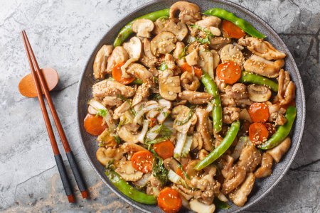 Moo Goo Gai Pan o Mah Gu Gai Pan es el plato chino de pollo con setas en salsa salada primer plano en el plato de la mesa. Vista superior horizontal desde arriba