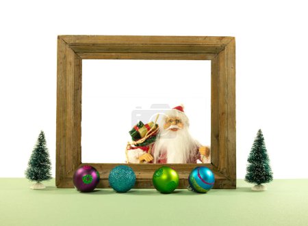 Photo for Modern Christmas tree decor with frame with santa cluas and ready for text and christmas baubles on a grain floor against a white background with copy space - Royalty Free Image