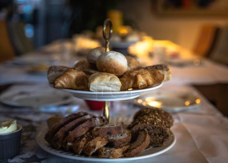Photo for Etagere with various sandwiches such as raisin bread balls and small croissants for lunch or breakfast - Royalty Free Image