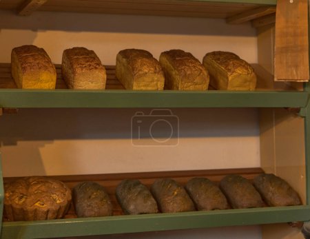 Photo for Wooden shelfs in a old bakery shop with different kind of bread - Royalty Free Image
