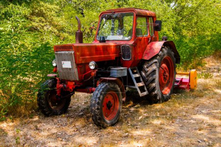 Photo for Old retro and red Soviet tractor is ready to work - Royalty Free Image
