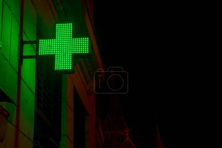 Photo for Green lighting cross in the darks street of Szeged - Royalty Free Image