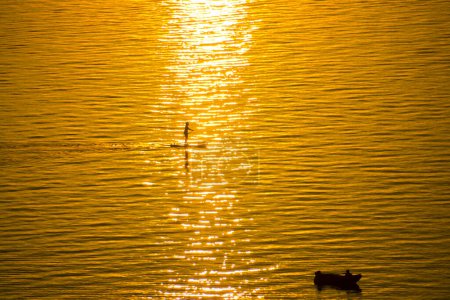 Photo for Standup paddleboarding in the sunset at Balatonvilagos near Lake Balaton in Summer - Royalty Free Image