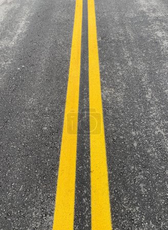 Photo for Twin lines painted in yellow colour on road asphalt - Royalty Free Image