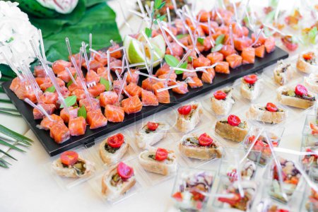 Téléchargez les photos : Canape with salmon, seafood and appetizers for guests - en image libre de droit