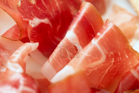 Photo for Closeup view of thin prosciutto slices - Royalty Free Image