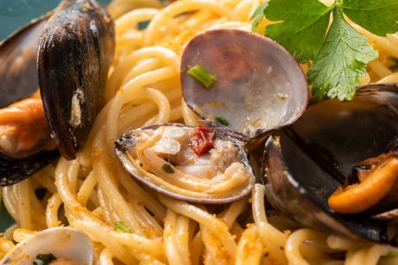 Dish of delicious spaghetti with mussels, clams and bottarga, italian food