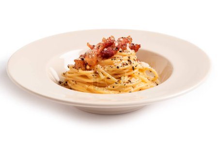 Photo for Delicious spaghetti alla carbonara, a traditional roman recipe of pasta topped with egg, pecorino and black pepper sauce, italian food - Royalty Free Image